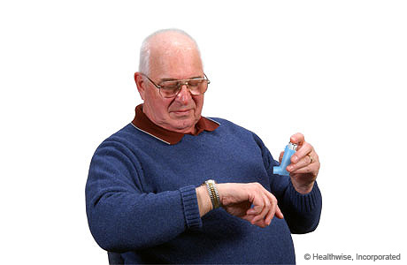 A man holding his breath while looking at his watch