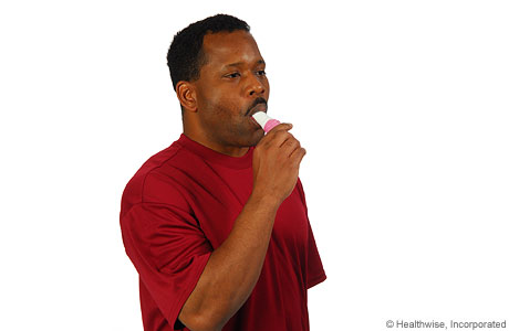 A man inhaling medicine